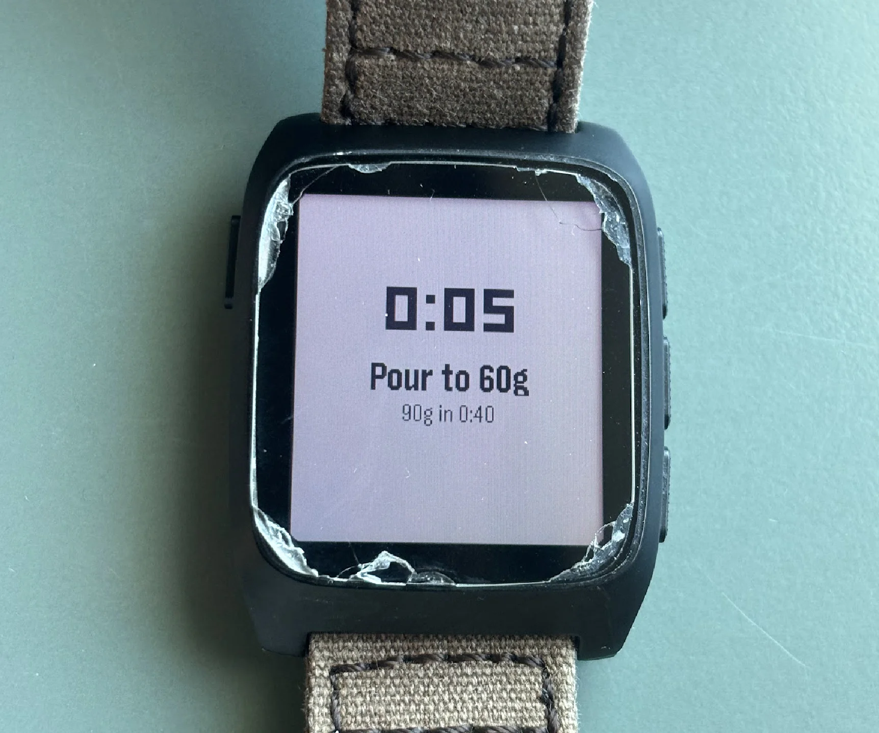 Photo of my Pebble watch, with text containing '0:05, Pour to 60g, 90g in 0:40'